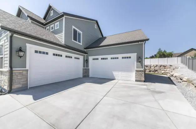 House with two white Garage Doors